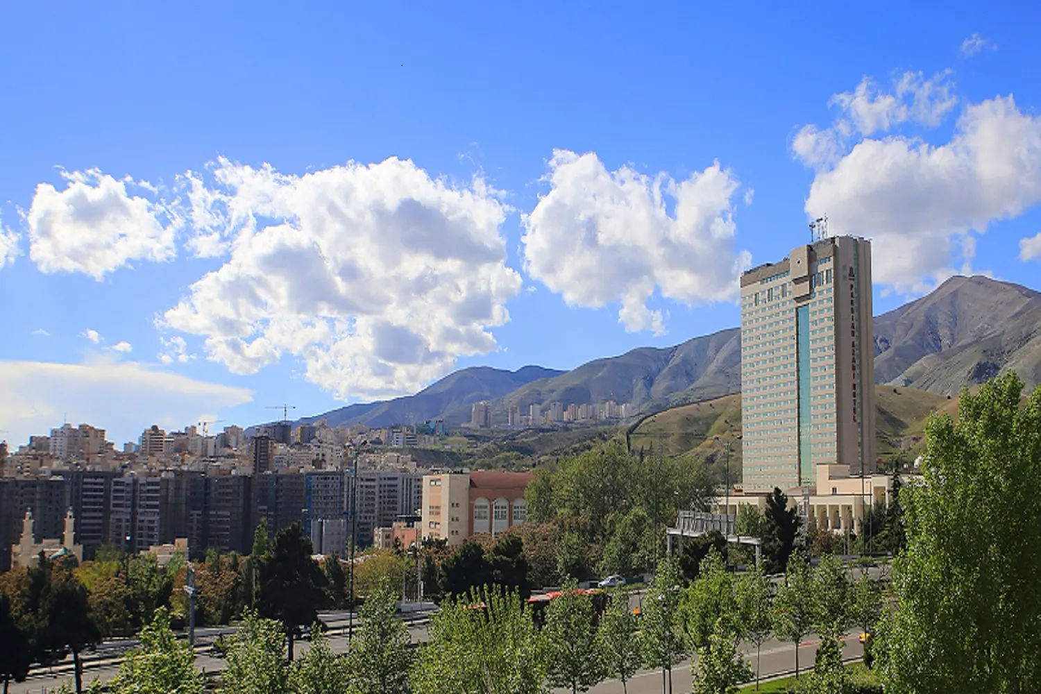 Parsian Azadi Hotel: A prominent five-star hotel with a panoramic view of the Alborz mountains.